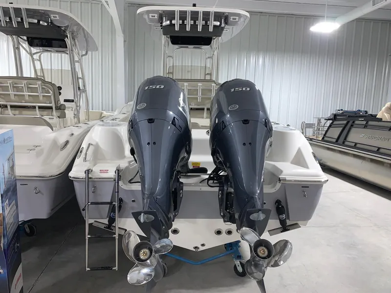 Slide: The Image of 2024 Key West 244 CC Manta Gray boat with twin outboard engines in a showroom. - 3