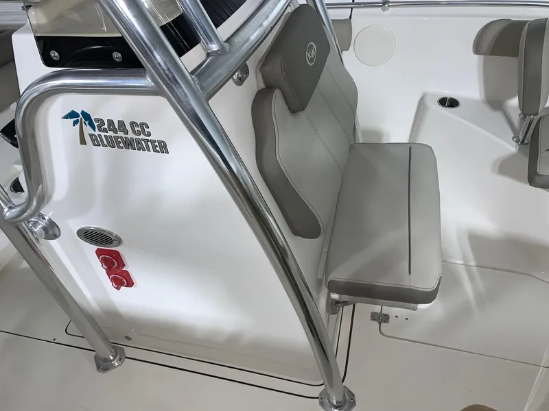 Slide: The Image of 2024 Key West 244 CC Manta Gray boat interior with seating and console. - 8