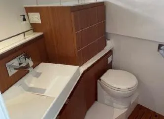 Slide: The Image of Modern bathroom on 2017 Evo Yachts 43 with wooden cabinetry and white fixtures. - 16