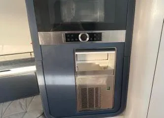 Slide: The Image of Built-in appliance on 2017 Evo Yachts 43, featuring a microwave and refrigerator. - 18