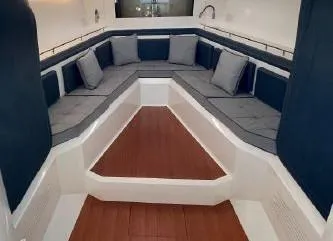 Slide: The Image of Interior seating area of 2017 Evo Yachts 43 with blue cushions and wooden flooring. - 19