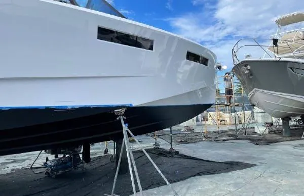 Slide: The Image of Evo Yachts 43, 2017 model, in dry dock for maintenance under a clear blue sky. - 26
