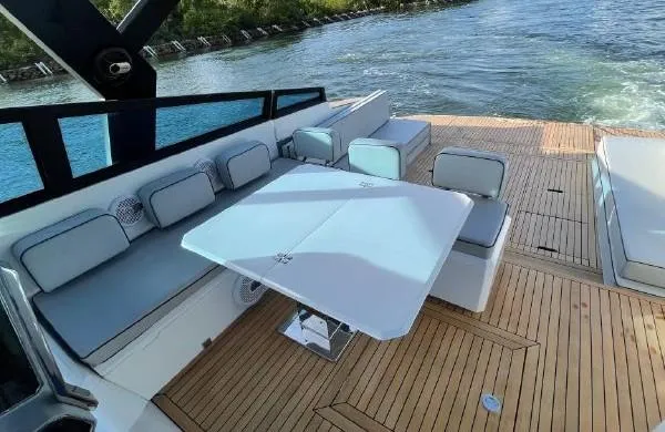 Slide: The Image of Spacious deck seating area on 2017 Evo Yachts 43 with modern table and scenic water view. - 9
