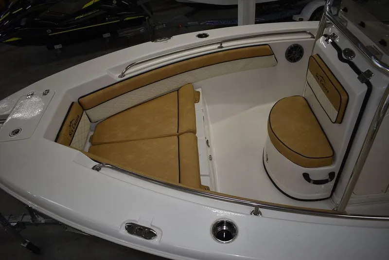 Slide: The Image of 2023 Sea Chaser 20 HFC boat interior with tan cushioned seating and white deck. - 10