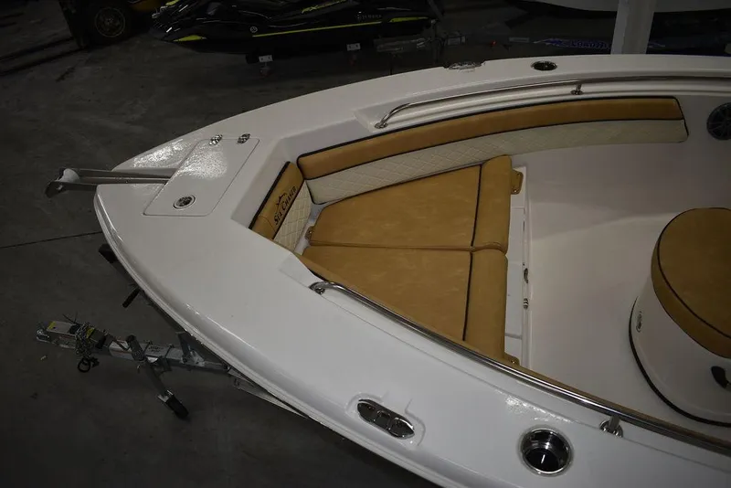Slide: The Image of 2023 Sea Chaser 20 HFC boat interior with tan seating and white deck. - 11