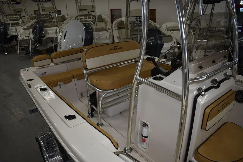 Slide: The Image of 2023 Sea Chaser 20 HFC boat interior with tan seating and stainless steel fixtures. - 15