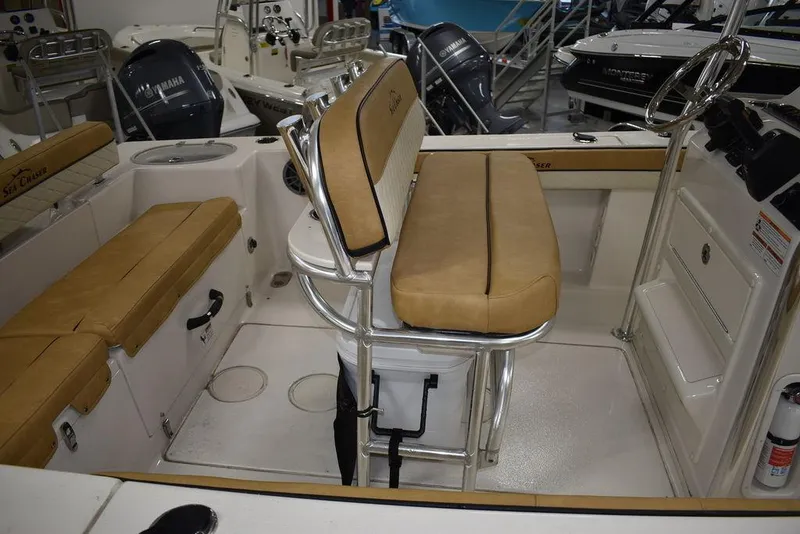 Slide: The Image of 2023 Sea Chaser 20 HFC boat interior with tan seating and stainless steel fixtures. - 17