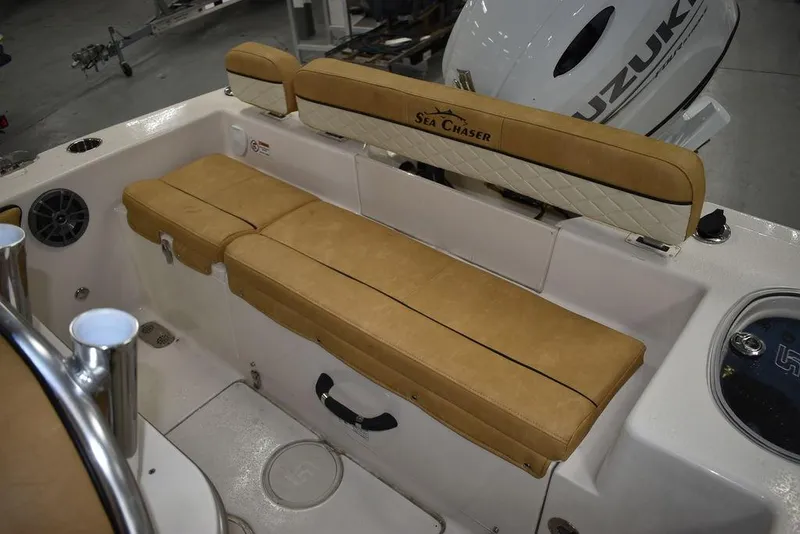 Slide: The Image of 2023 Sea Chaser 20 HFC boat interior with tan cushioned seating and Suzuki outboard motor. - 18