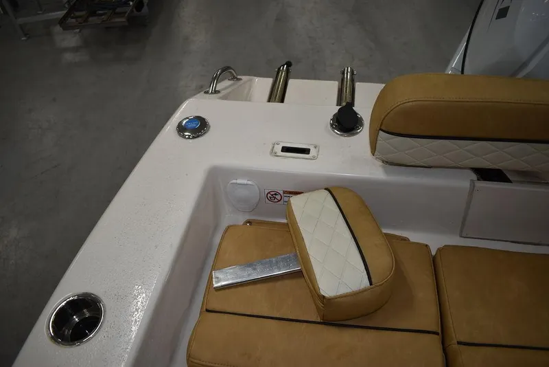 Slide: The Image of 2023 Sea Chaser 20 HFC boat interior with tan cushioned seating and stainless steel fixtures. - 22