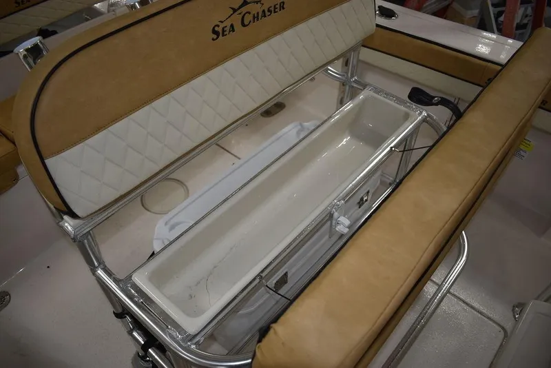 Slide: The Image of 2023 Sea Chaser 20 HFC boat with tan and white seating and storage compartment. - 27