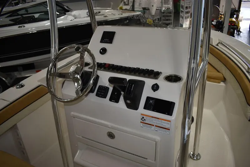 Slide: The Image of 2023 Sea Chaser 20 HFC boat console with steering wheel and controls. - 28