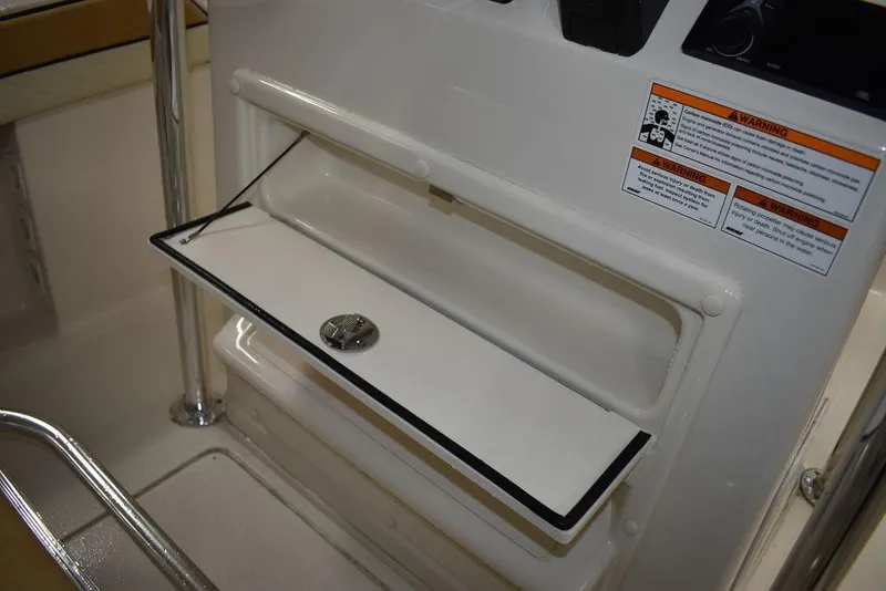 Slide: The Image of 2023 Sea Chaser 20 HFC storage compartment with safety warnings. - 30