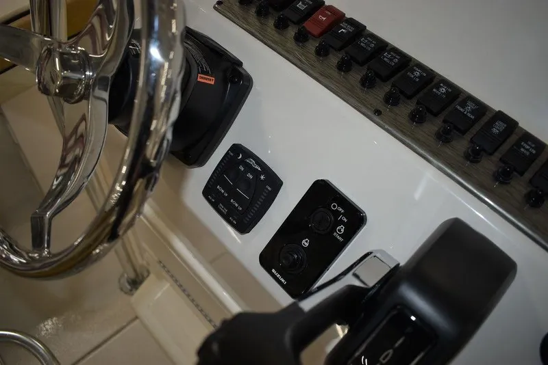 Slide: The Image of Close-up of the 2023 Sea Chaser 20 HFC boat's control panel and steering wheel. - 33