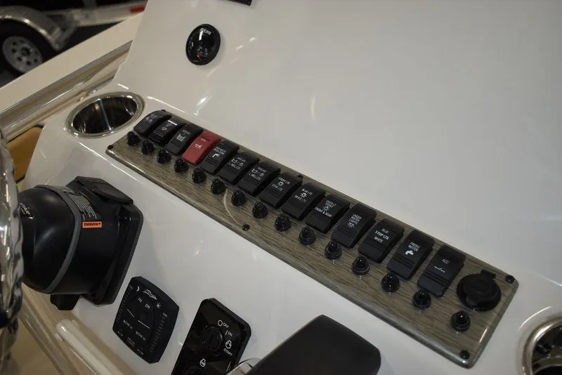 Slide: The Image of Control panel of a 2023 Sea Chaser 20 HFC boat with various switches and gauges. - 35