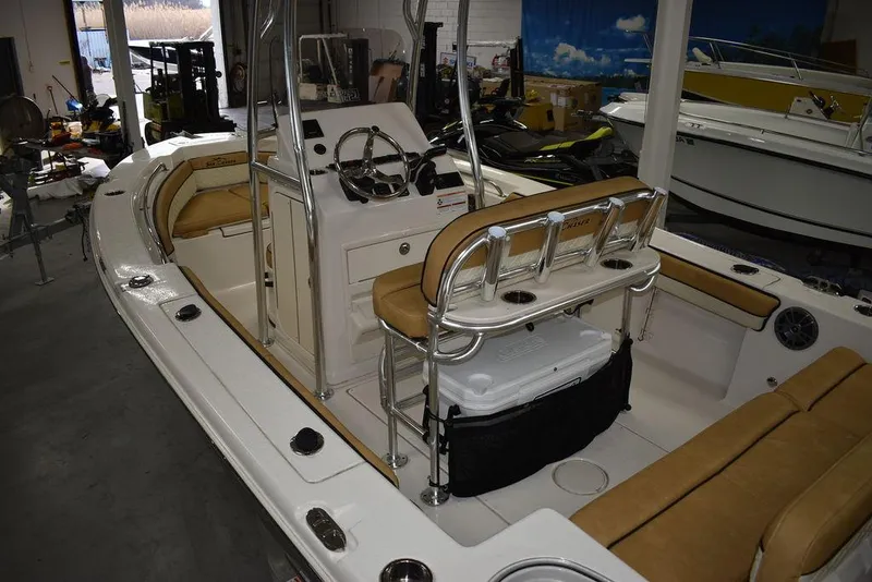 Slide: The Image of 2023 Sea Chaser 20 HFC boat interior with tan seating and modern controls. - 7