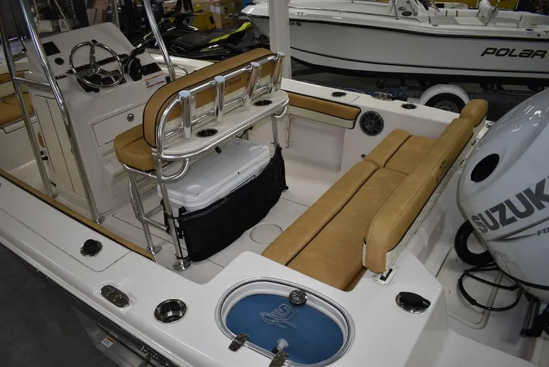 Slide: The Image of 2023 Sea Chaser 20 HFC boat interior with tan seating and Suzuki outboard motor. - 8