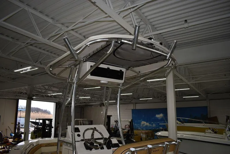 Slide: The Image of 2023 Sea Chaser 20 HFC boat interior with T-top in a showroom. - 9