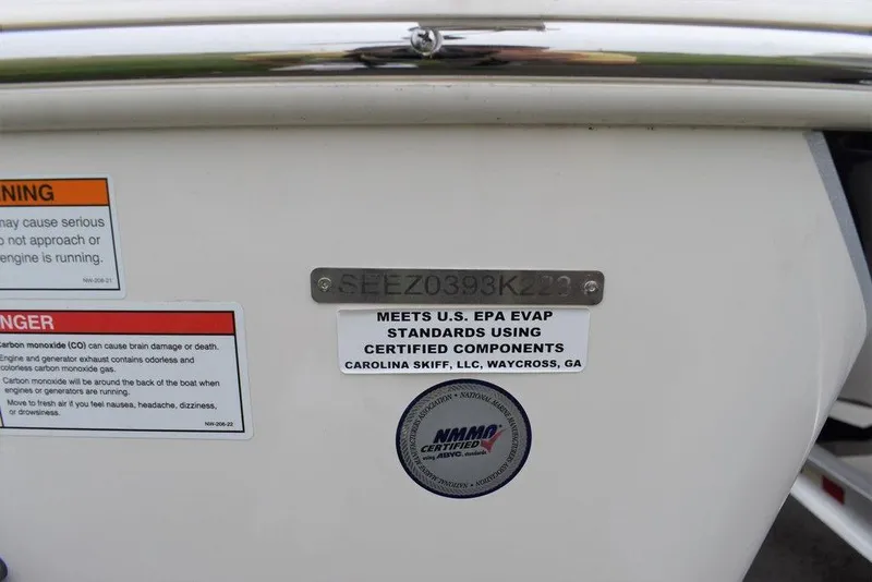 Slide: The Image of 2023 Sea Chaser 22 HFC boat compliance and warning labels on the hull. - 16