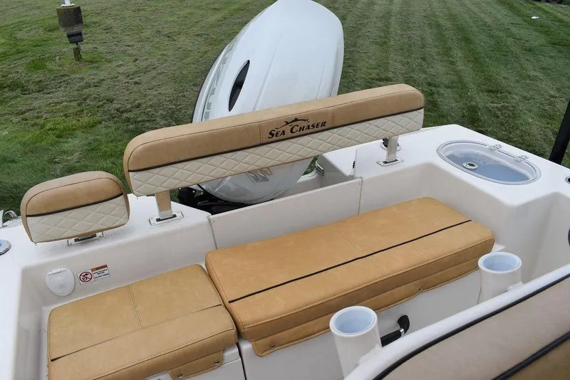 Slide: The Image of 2023 Sea Chaser 22 HFC boat with tan seating and white motor. - 7