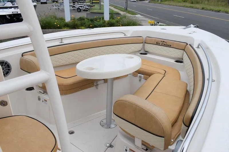 Slide: The Image of 2023 Sea Chaser 22 HFC boat with tan seating and round table. - 9