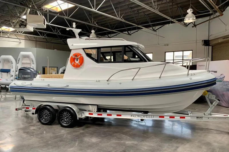 The Image of 2023 Flexboat 680 Explorer with Yamaha 250, displayed on a trailer in a showroom. - 1