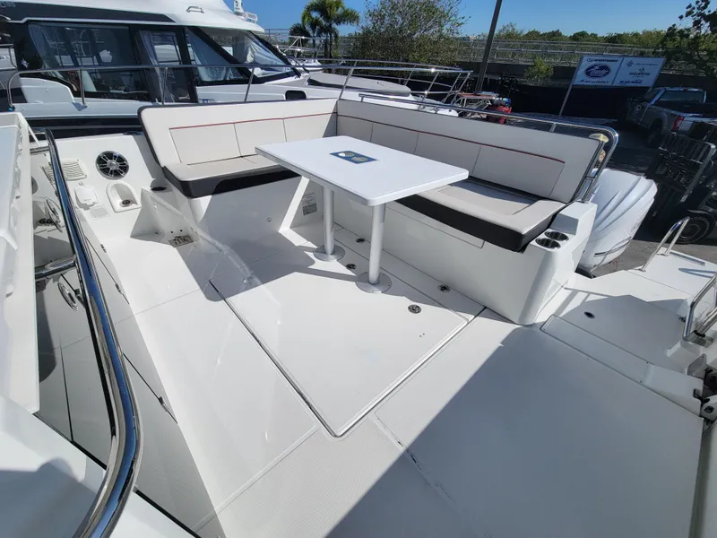 Slide: The Image of Spacious seating area on the 2024 Jeanneau Leader 12.5 WA yacht with a central table. - 10
