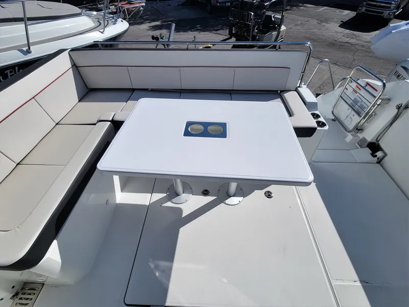 Slide: The Image of 2024 Jeanneau Leader 12.5 WA boat with spacious seating and table in the cockpit area. - 11