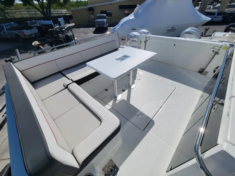 Slide: The Image of 2024 Jeanneau Leader 12.5 WA boat with spacious seating and table in the cockpit area. - 12