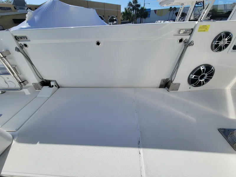 Slide: The Image of 2024 Jeanneau Leader 12.5 WA boat deck with speakers and storage compartment. - 13