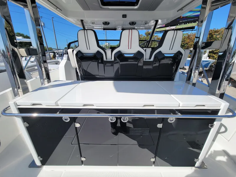 Slide: The Image of 2024 Jeanneau Leader 12.5 WA boat interior with modern seating and sleek design. - 14