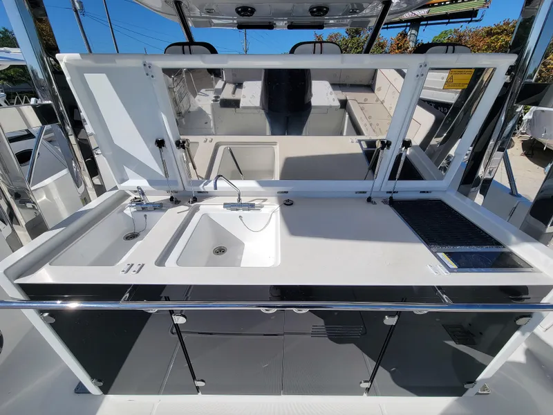 Slide: The Image of 2024 Jeanneau Leader 12.5 WA boat kitchen area with sink and counter space. - 18