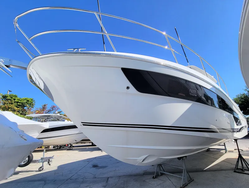 Slide: The Image of 2024 Jeanneau Leader 12.5 WA boat on display under clear blue sky. - 2
