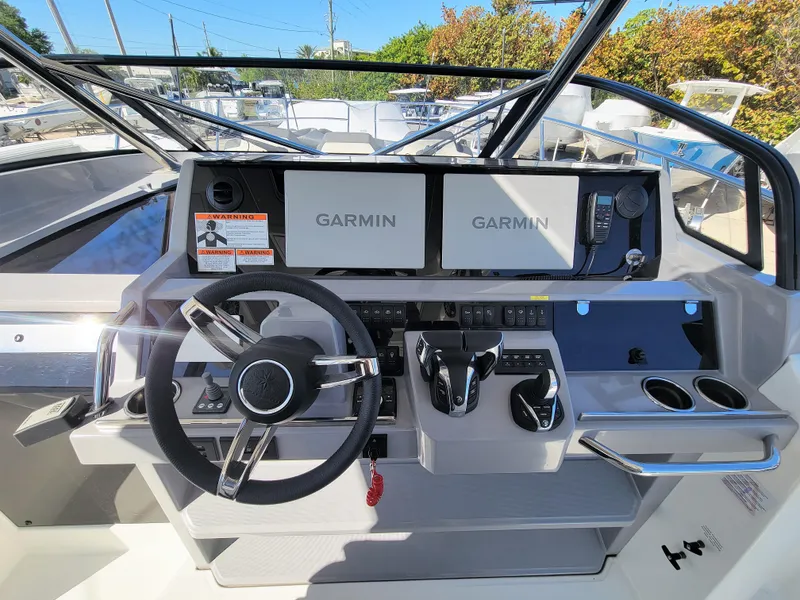 Slide: The Image of 2024 Jeanneau Leader 12.5 WA helm with dual Garmin displays and modern controls. - 23