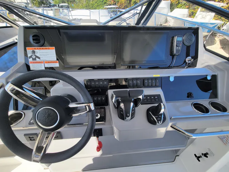 Slide: The Image of 2024 Jeanneau Leader 12.5 WA helm station with modern controls and navigation screens. - 24