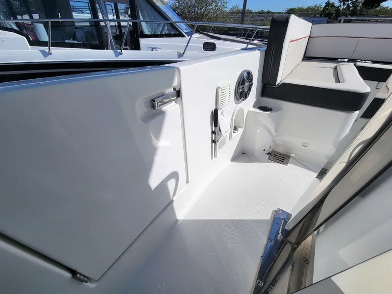 Slide: The Image of 2024 Jeanneau Leader 12.5 WA boat interior with seating and storage compartments. - 25
