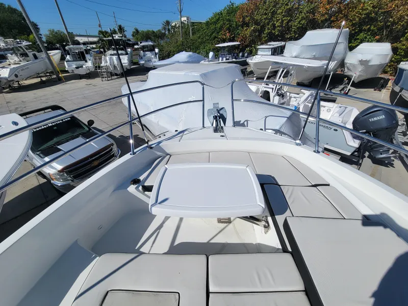 Slide: The Image of 2024 Jeanneau Leader 12.5 WA boat with spacious deck and seating area. - 32