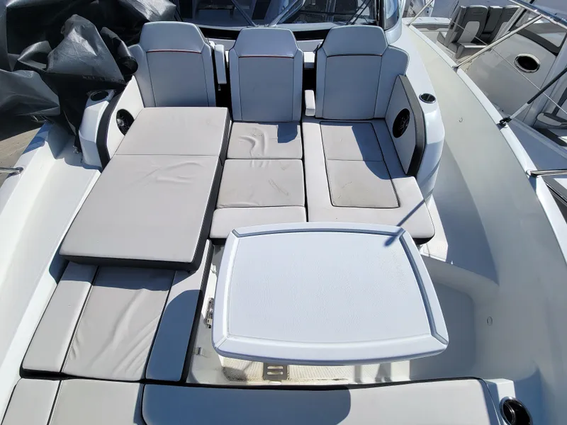 Slide: The Image of 2024 Jeanneau Leader 12.5 WA boat with spacious seating and table. - 34