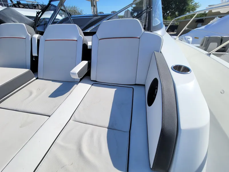 Slide: The Image of 2024 Jeanneau Leader 12.5 WA boat interior seating area with white cushions. - 35