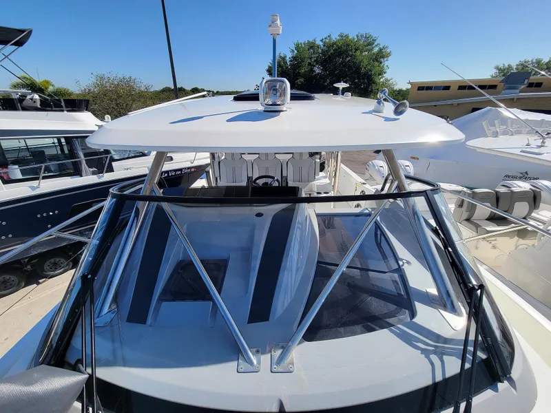 Slide: The Image of 2024 Jeanneau Leader 12.5 WA boat docked, front view. - 37