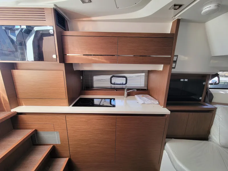 Slide: The Image of 2024 Jeanneau Leader 12.5 WA interior kitchen with modern wood cabinetry and sleek design. - 42