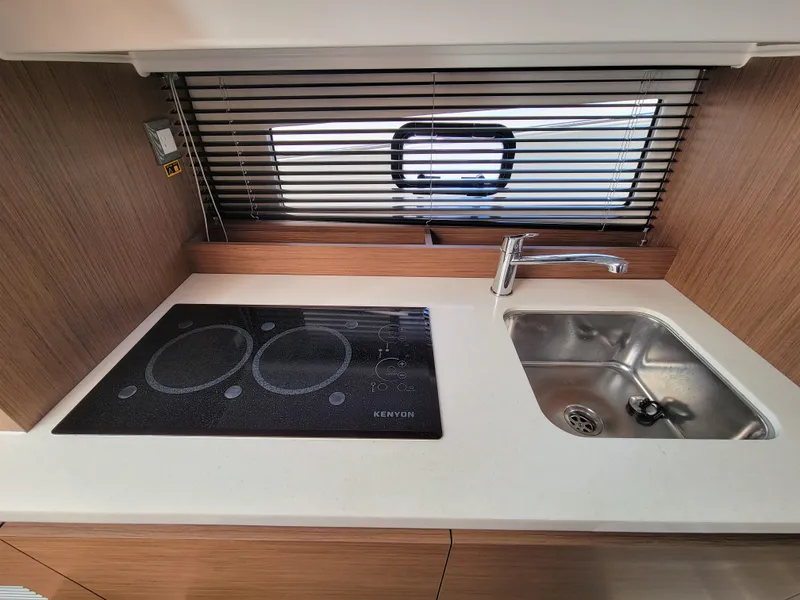 Slide: The Image of 2024 Jeanneau Leader 12.5 WA kitchen with stove and sink. - 44