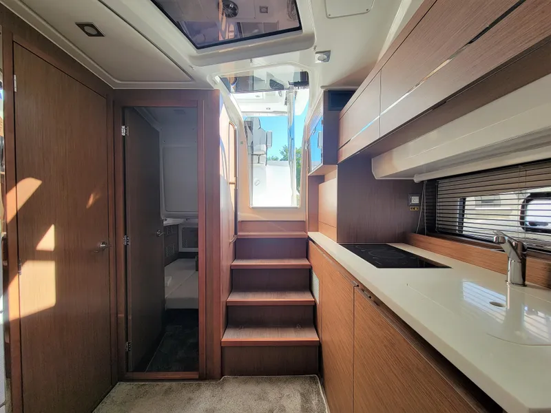 Slide: The Image of 2024 Jeanneau Leader 12.5 WA interior with modern kitchen and wooden finishes. - 45