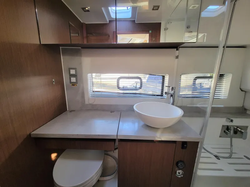 Slide: The Image of 2024 Jeanneau Leader 12.5 WA bathroom with modern fixtures and wood cabinetry. - 47
