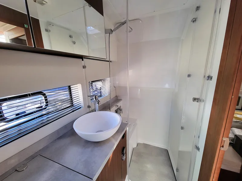 Slide: The Image of Modern bathroom in 2024 Jeanneau Leader 12.5 WA boat with sink and shower. - 48