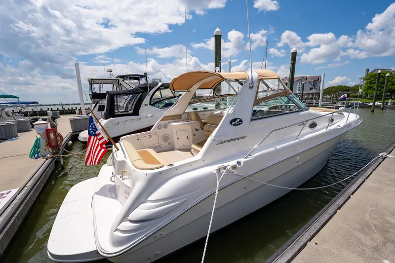 Slide: The Image of 1997 Sea Ray 330 Sundancer docked at marina under blue sky. - 11