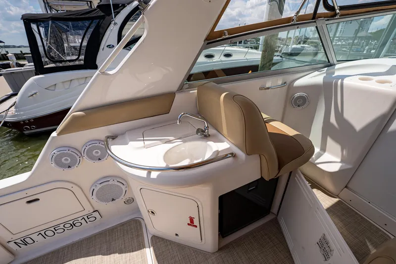 Slide: The Image of 1997 Sea Ray 330 Sundancer boat interior with sink and seating area. - 15