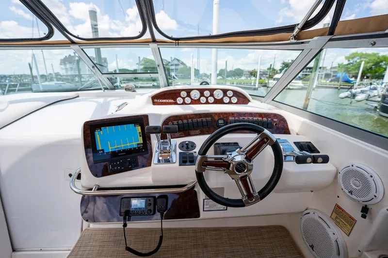 Slide: The Image of Cockpit of 1997 Sea Ray 330 Sundancer with steering wheel and navigation equipment. - 18