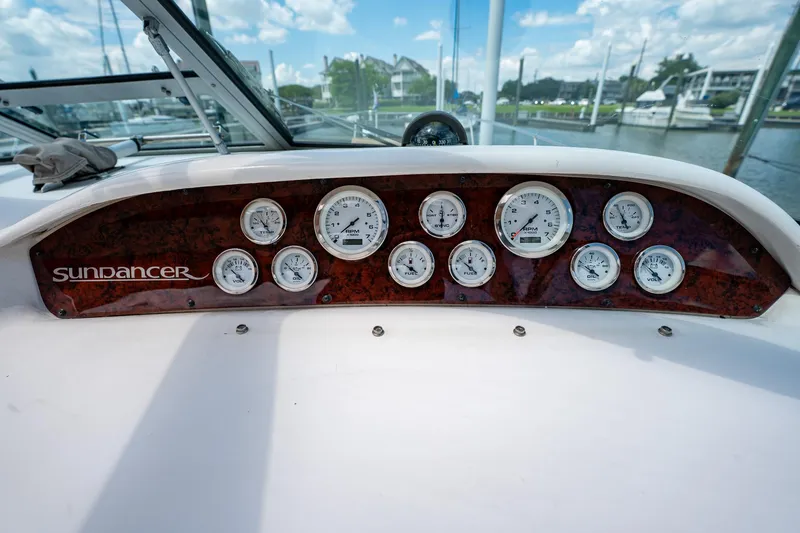 Slide: The Image of Dashboard of a 1997 Sea Ray 330 Sundancer boat with multiple gauges. - 20