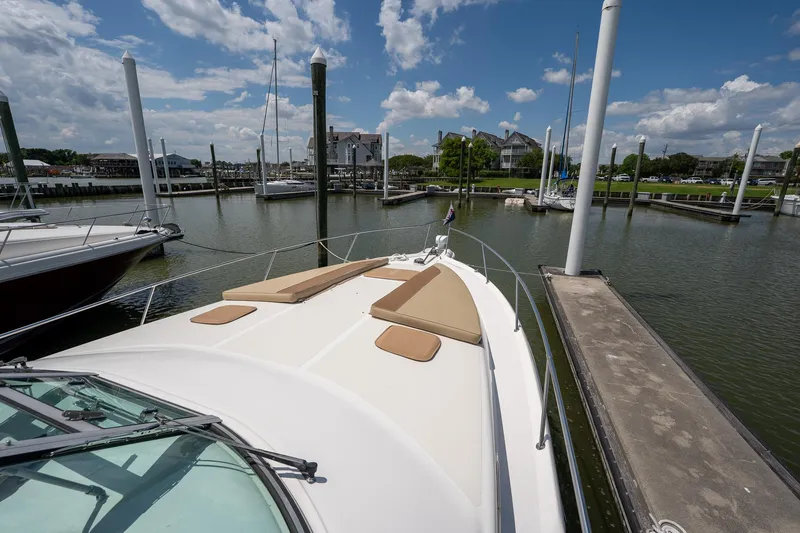 Slide: The Image of 1997 Sea Ray 330 Sundancer docked in a marina under a clear blue sky. - 22
