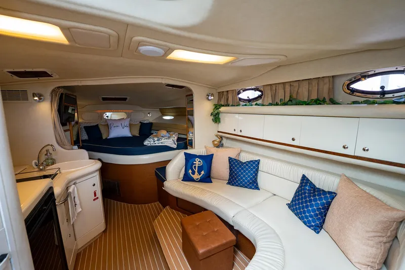 Slide: The Image of Interior of 1997 Sea Ray 330 Sundancer yacht with cozy seating and nautical decor. - 24